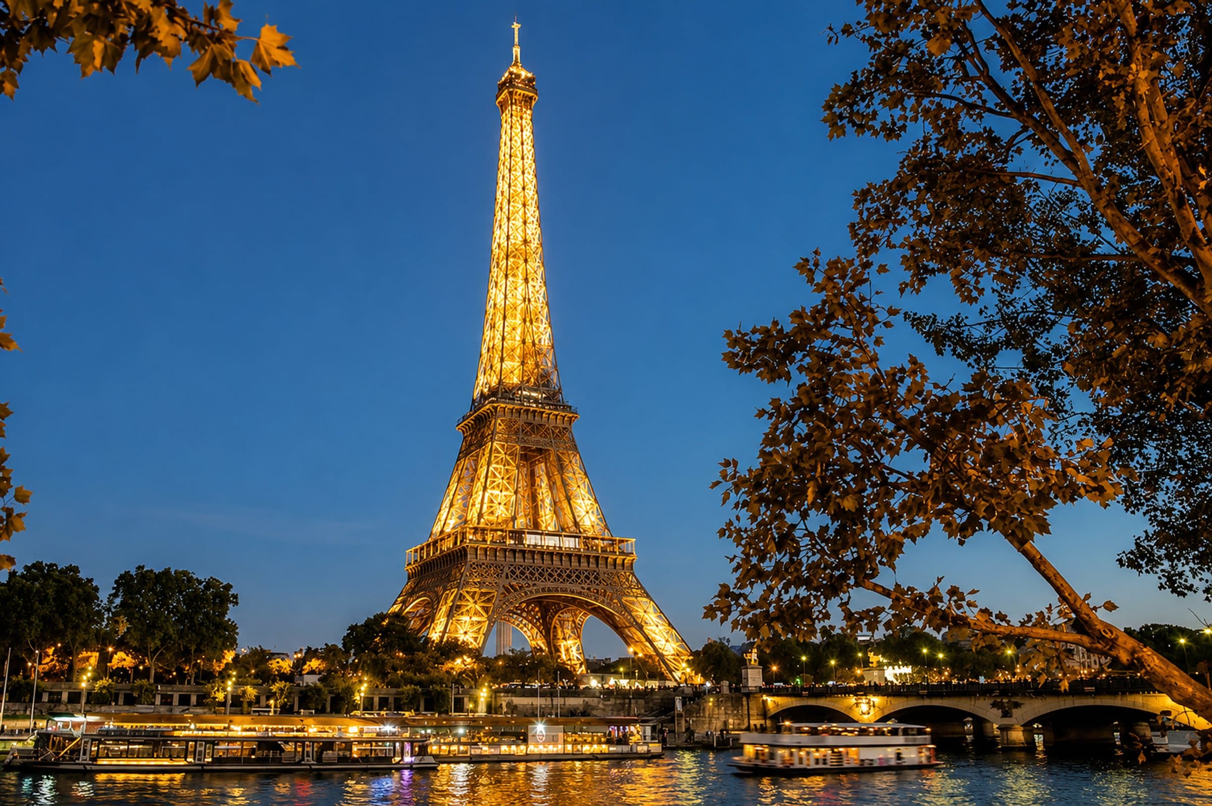 The Eiffel Tower illuminated at night above the Seine
